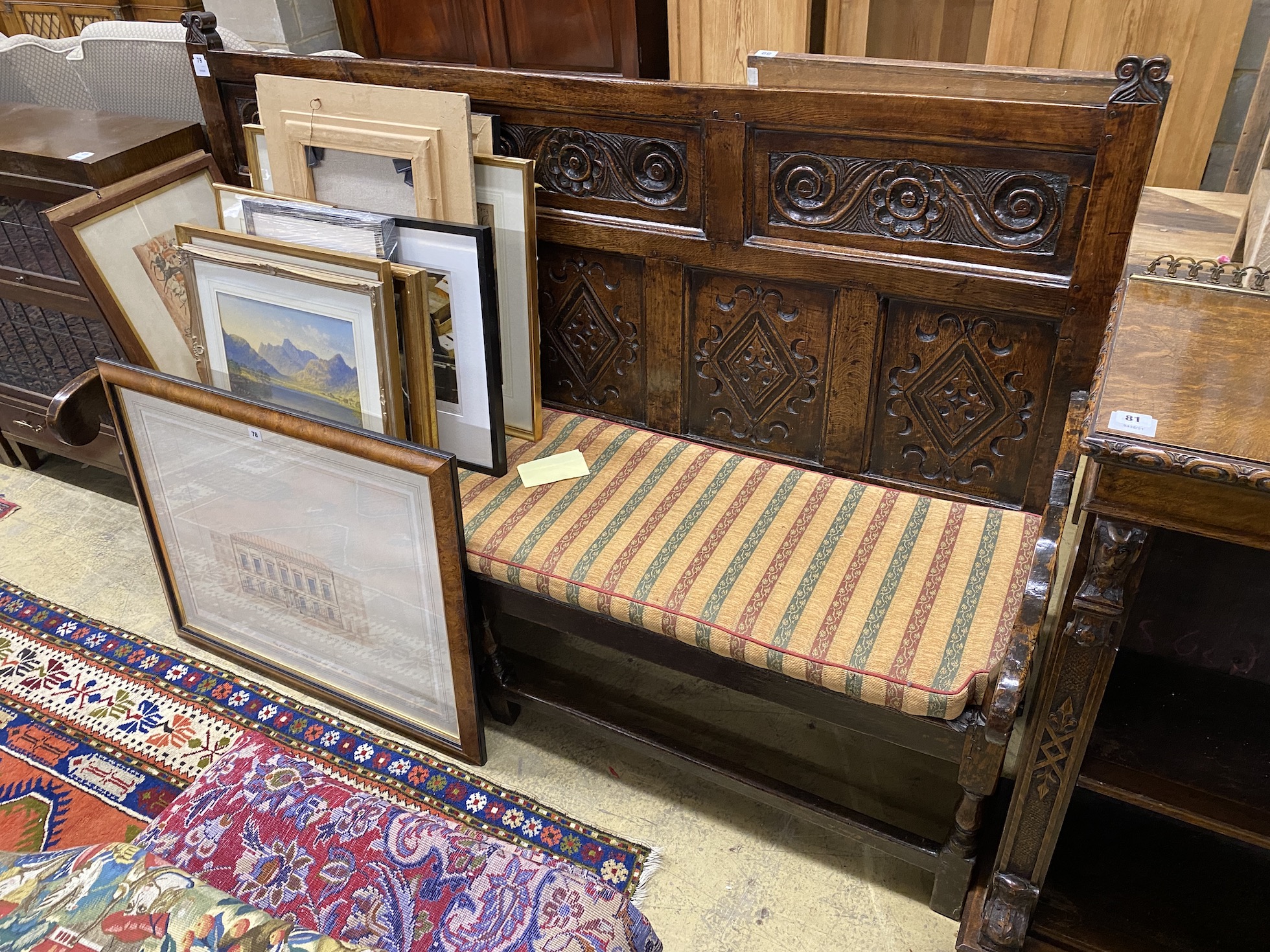 An 18th century carved oak settle, width 187cm, depth 60cm, height 123cm